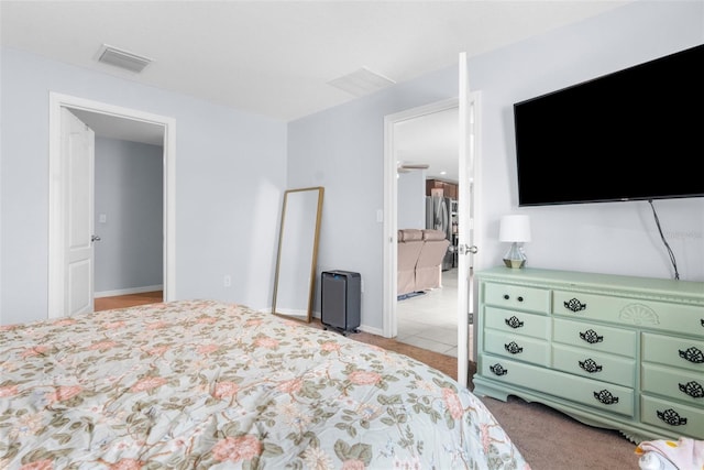 carpeted bedroom with stainless steel fridge