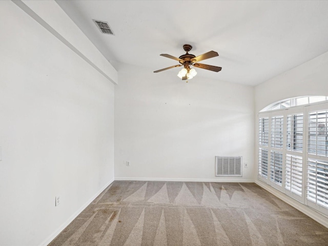 carpeted spare room featuring ceiling fan