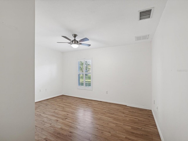 spare room featuring hardwood / wood-style flooring and ceiling fan