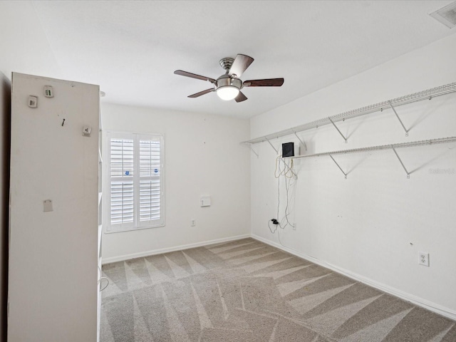 carpeted empty room featuring ceiling fan