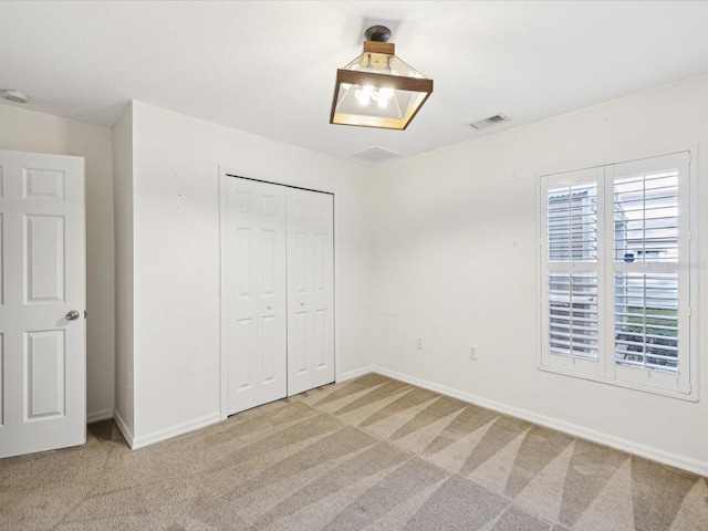 unfurnished bedroom featuring a closet and carpet flooring