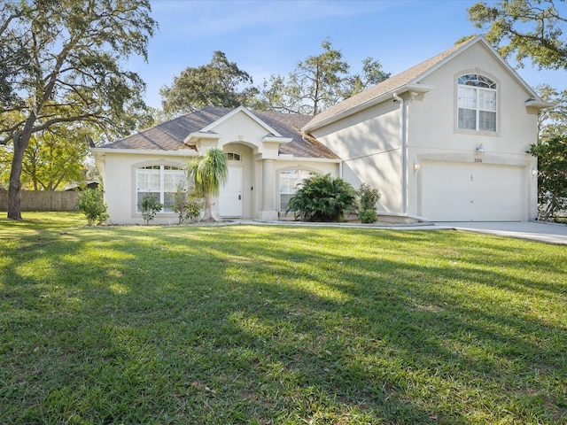 view of front of home featuring a front yard and a garage