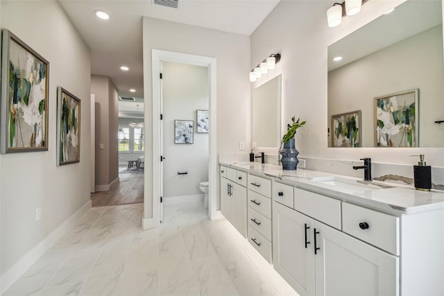 bathroom featuring toilet and vanity