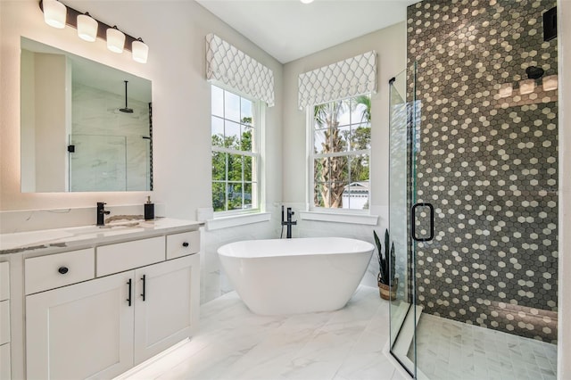 bathroom with vanity and shower with separate bathtub