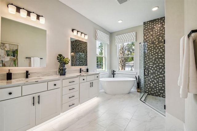 bathroom featuring vanity and shower with separate bathtub