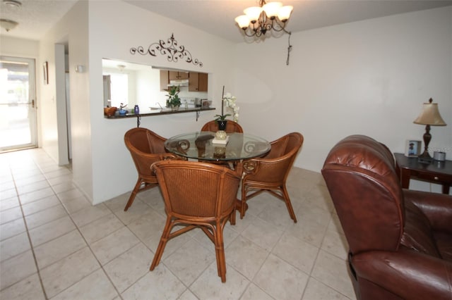 dining space featuring an inviting chandelier and light tile patterned floors