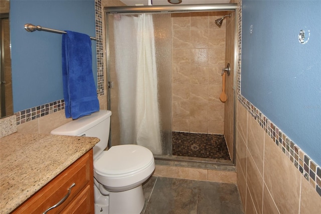 bathroom with vanity, toilet, tile walls, and a shower with shower curtain