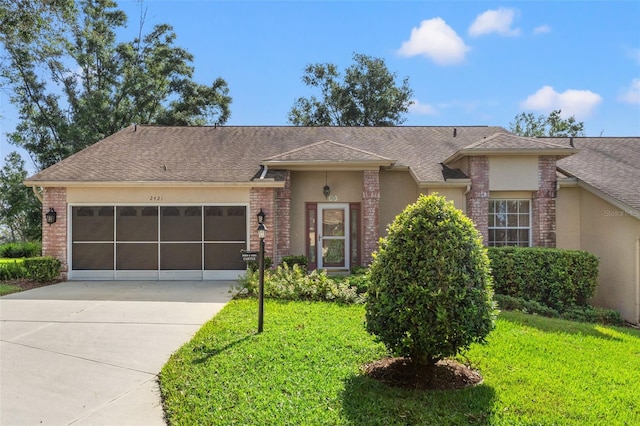 ranch-style home with a front lawn and a garage