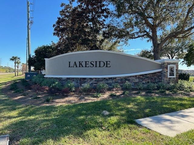 community / neighborhood sign with a lawn