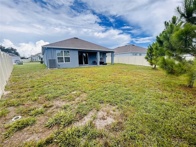 back of property featuring a lawn