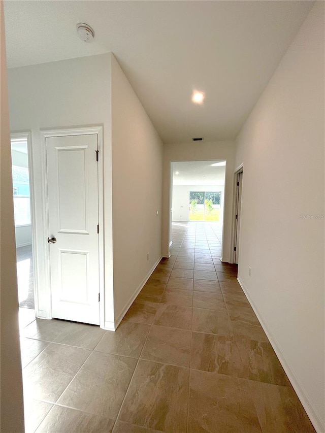 corridor featuring light tile patterned floors