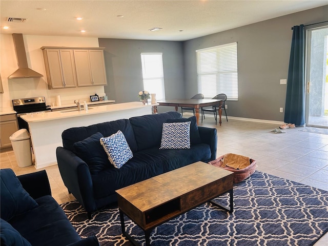 tiled living room featuring sink