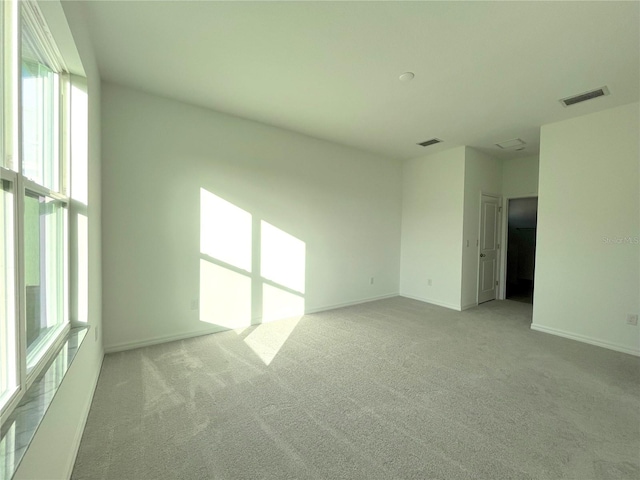 unfurnished room with light colored carpet