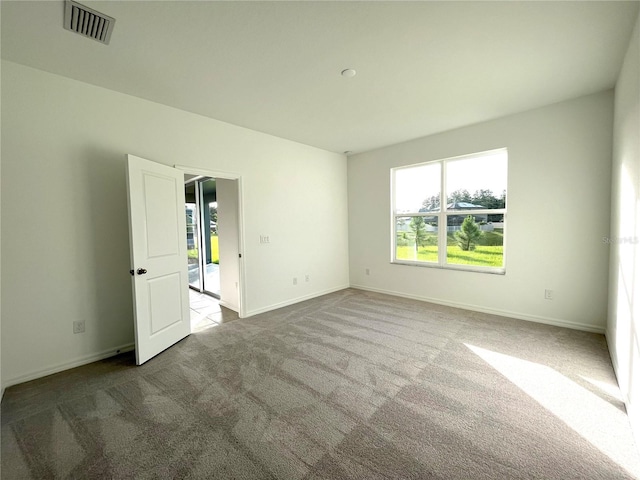 spare room featuring light colored carpet