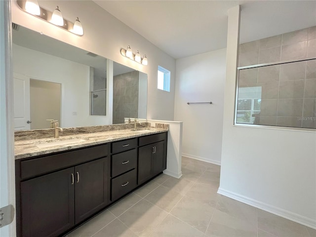 bathroom featuring walk in shower, double vanity, baseboards, and tile patterned flooring