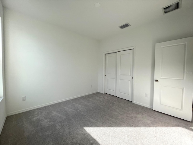 unfurnished bedroom with a closet and carpet