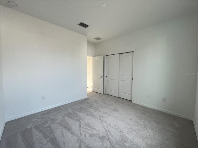 unfurnished bedroom with carpet floors and a closet