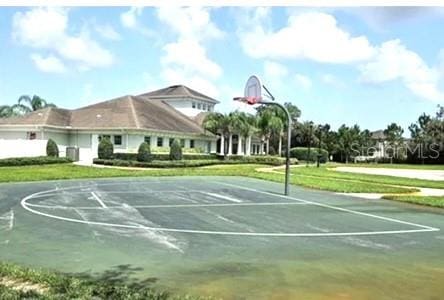 view of basketball court with a lawn