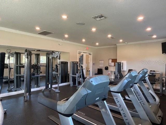 gym with crown molding and a textured ceiling