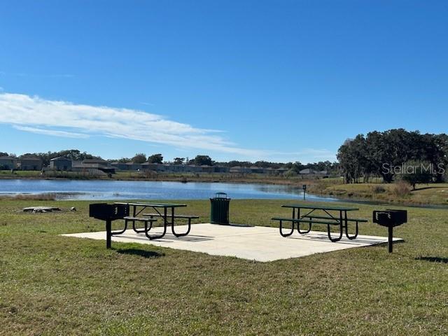 view of community featuring a yard and a water view