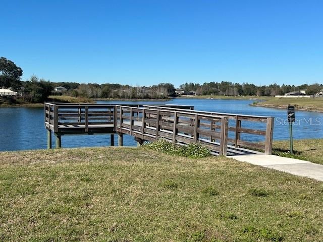 dock area featuring a yard and a water view