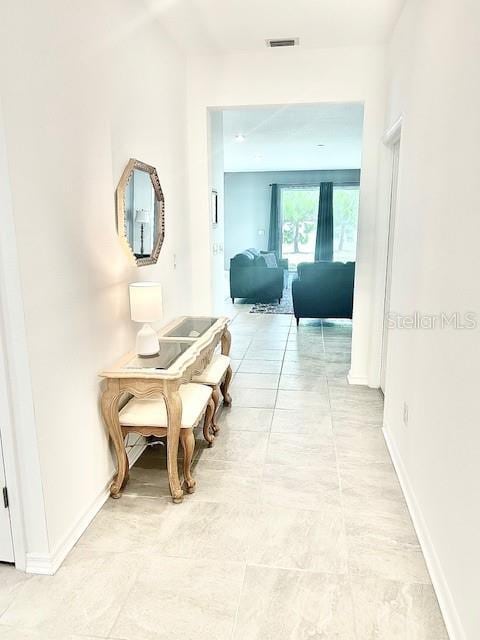 13447 Newport Shores Dr, Hudson, FL 34669 - corridor featuring baseboards and light tile patterned floors