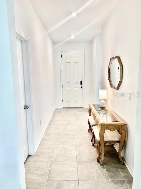 13447 Newport Shores Dr, Hudson, FL 34669 - entrance foyer featuring baseboards and light tile patterned floors