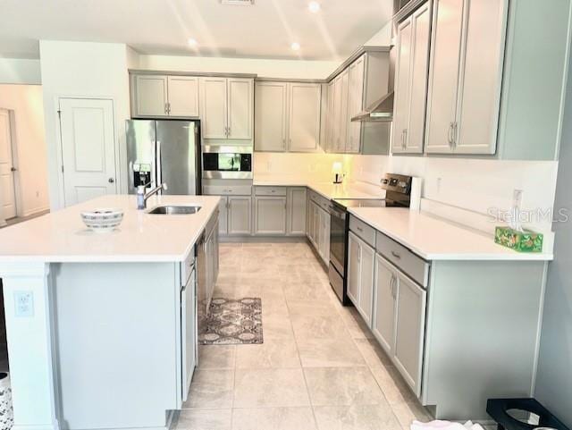 13447 Newport Shores Dr, Hudson, FL 34669 - kitchen with appliances with stainless steel finishes, gray cabinets, a kitchen island with sink, and recessed lighting