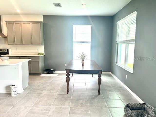 13447 Newport Shores Dr, Hudson, FL 34669 - dining space with light tile patterned flooring