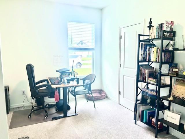 13447 Newport Shores Dr, Hudson, FL 34669 - carpeted home office featuring baseboards