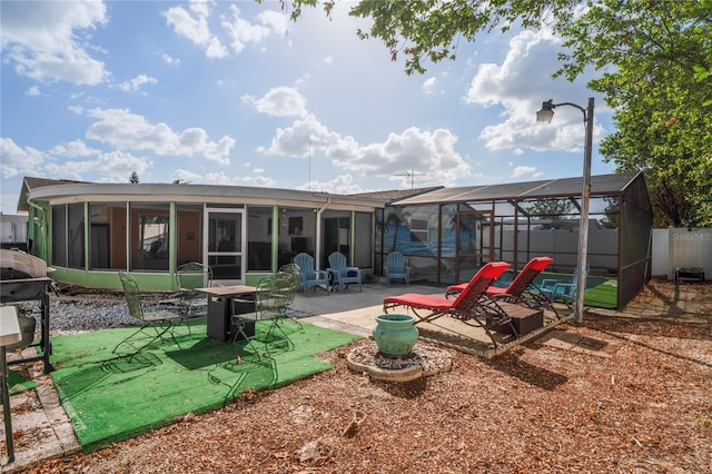 back of house with a lanai and a patio area