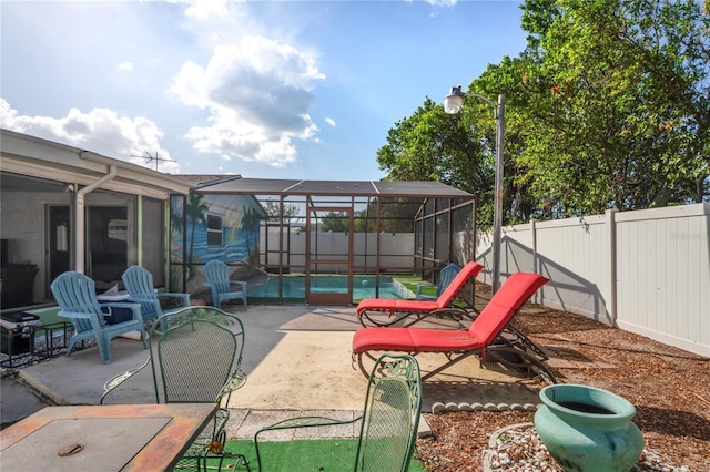 view of patio featuring a fenced in pool and glass enclosure