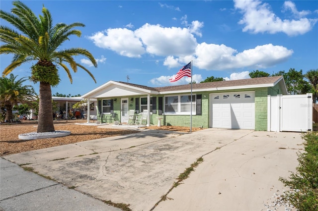 ranch-style house featuring a porch and a garage