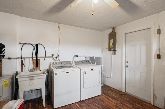 laundry area featuring dark hardwood / wood-style flooring, washer and clothes dryer, ceiling fan, water heater, and electric panel