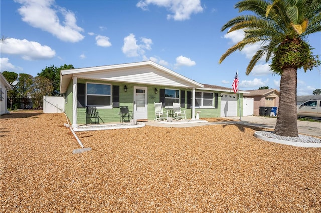 view of front of property with a porch and a garage