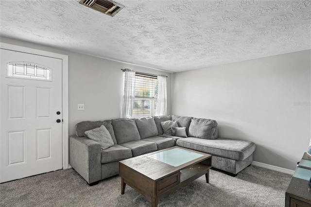 living room with carpet floors and a textured ceiling