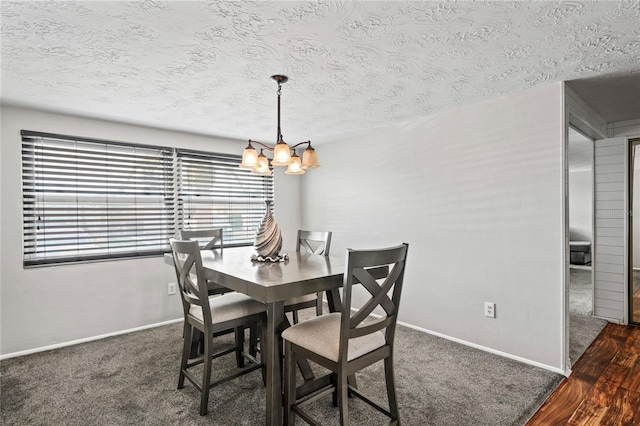 dining room with a notable chandelier, dark hardwood / wood-style flooring, and a textured ceiling