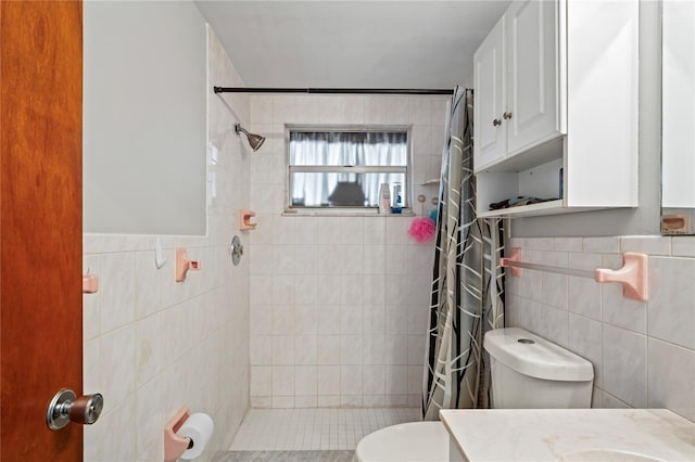 bathroom with vanity, toilet, tile walls, and curtained shower