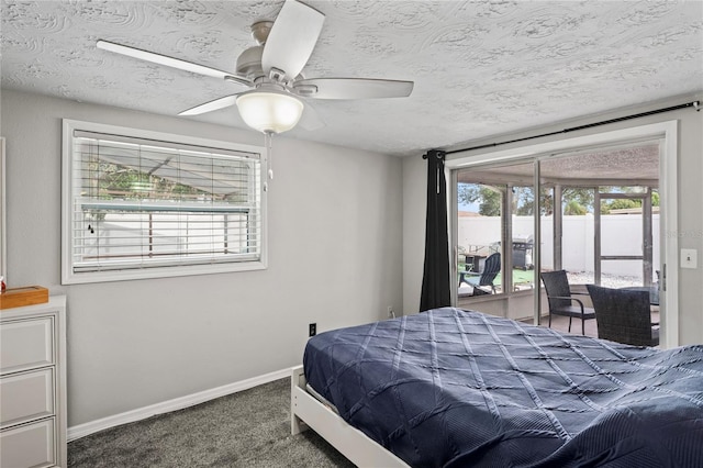 carpeted bedroom featuring multiple windows, ceiling fan, and a textured ceiling