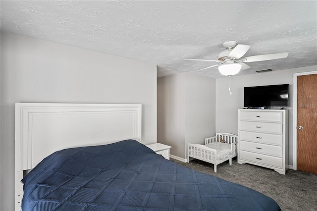 carpeted bedroom with a textured ceiling and ceiling fan