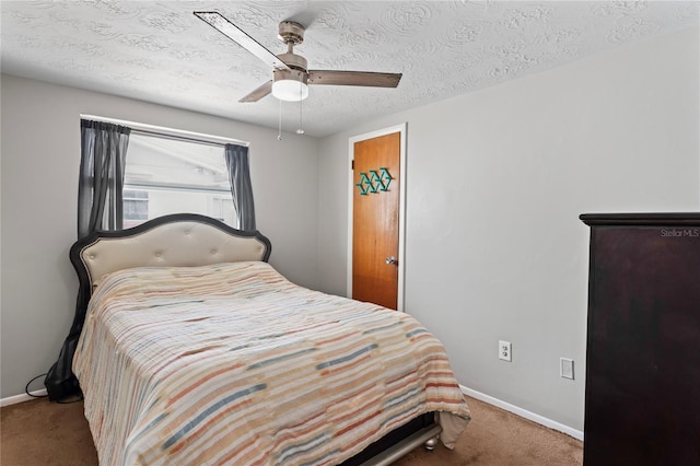 carpeted bedroom featuring a textured ceiling and ceiling fan