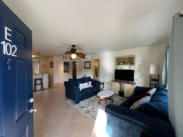 tiled living room featuring ceiling fan