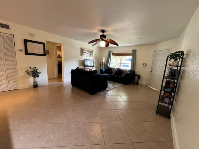 living room featuring ceiling fan and light tile patterned floors