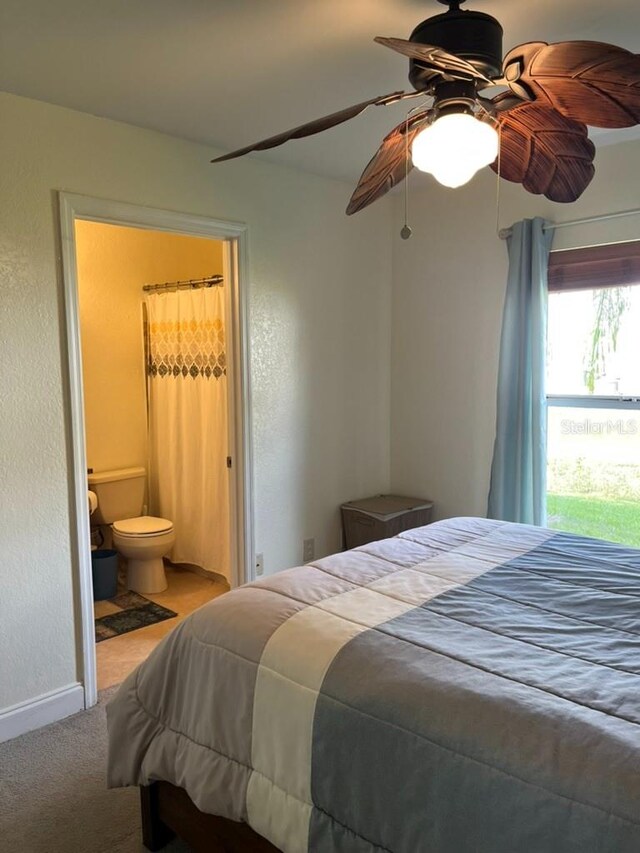 bedroom featuring connected bathroom, ceiling fan, and carpet