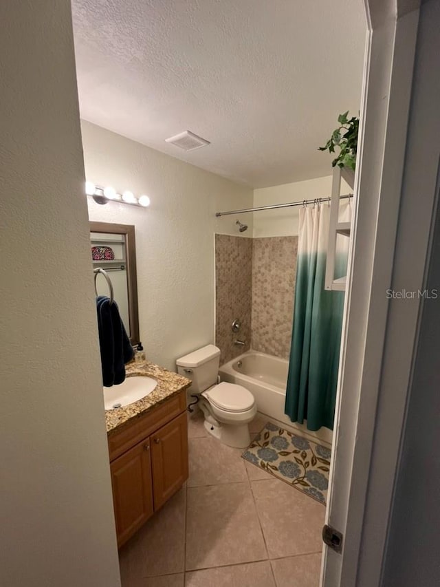 full bathroom featuring shower / tub combo, a textured ceiling, toilet, vanity, and tile patterned flooring