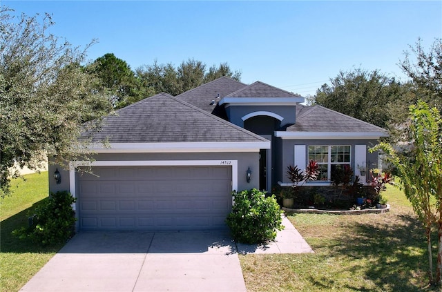 single story home featuring a front yard and a garage