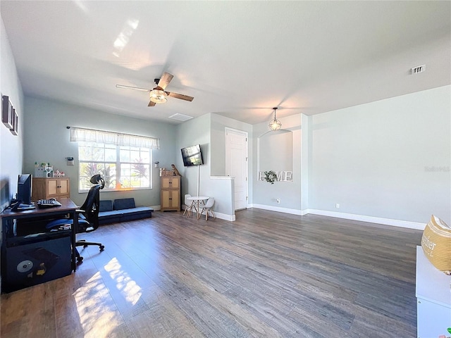 home office featuring dark wood-type flooring and ceiling fan