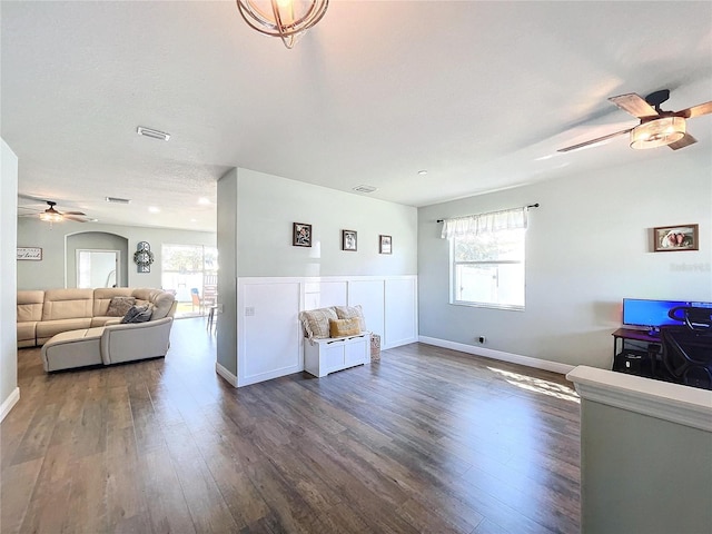 living room featuring a textured ceiling, plenty of natural light, and dark hardwood / wood-style flooring