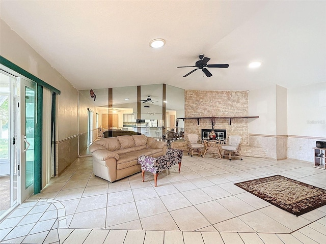 tiled living room featuring ceiling fan and lofted ceiling