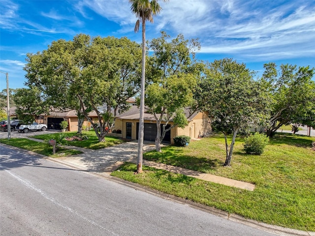 view of front of home featuring a garage and a front lawn